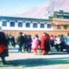 Tibetan crowd on the roof of a temple